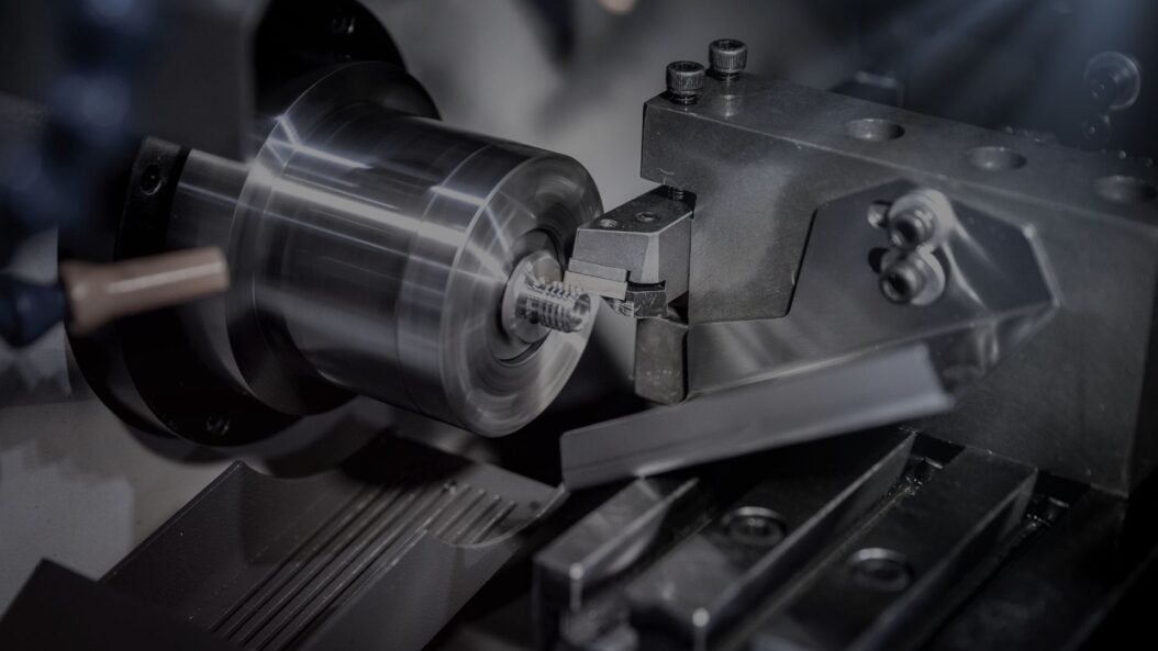 CNC machine creating a thread on a bolt.